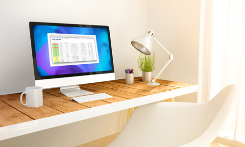 Desk with a computer monitor: "Cost Per Use" spreadsheet on screen.