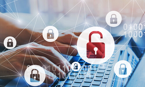 Conceptual data breach art with hand typing on keyboard and a lock sign superimposed in front.