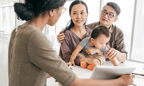 Young family sitting down with a financial advisor.