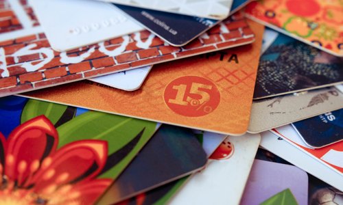 Stack of gift cards on a table from various vendors.