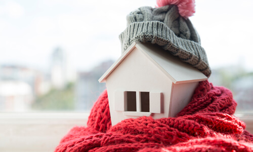 Model house wrapped in scarf and hat.