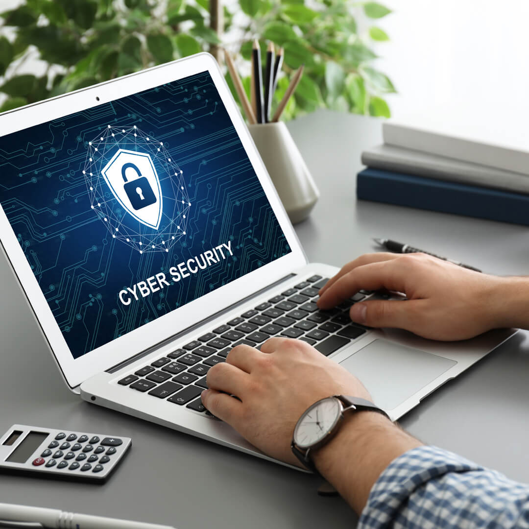 Closeup of computer screen and keyboard, with "Cybersecurity" written on monitor.