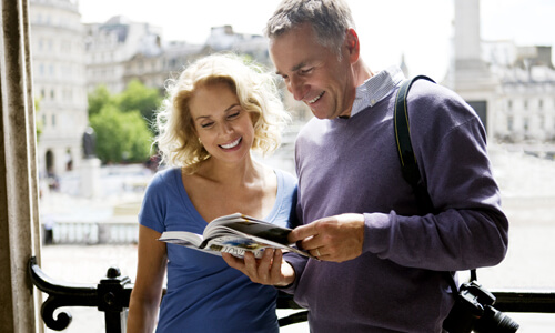 Couple consults a London Travel Guide while traveling abroad.