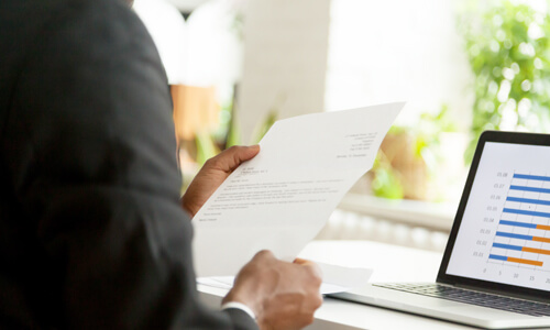 Closeup of recruiter reading a cover letter from a job candidate.