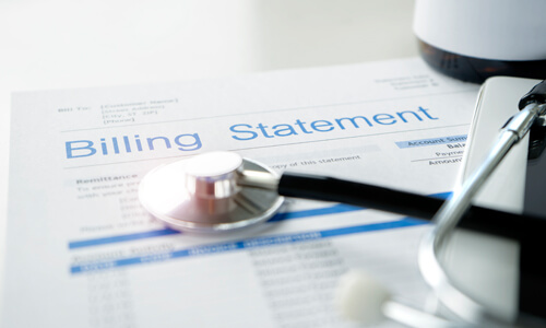 Medical bill statement with stethoscope over it.