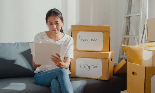 Woman looks at checklist while planning for her long-distance move.