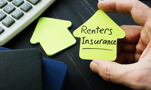 Renters Insurance written on notepad next to calculator