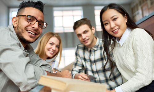 Group of college students smiling at camera.