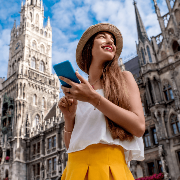 A young lady, wearing a hat and draped in a sun-kissed yellow skirt, gazes upon the splendid locale she has seamlessly journeyed to, courtesy of her Quorum Mastercard.