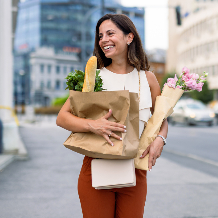 Woman walking in the city with groceries.