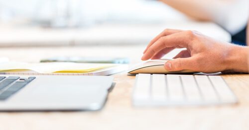 Close-up of hand on mouse, investigating an abandoned property list.