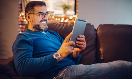 Man at home looking at tablet