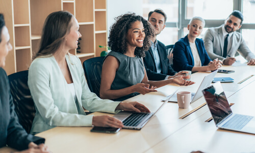 Smiling careerwoman leading business meeting in conference room.