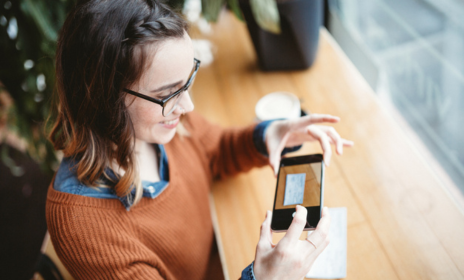 Woman using mobile deposit on mobile phone