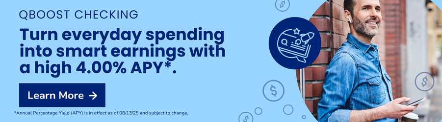 Smiling man on the street looking at his phone.