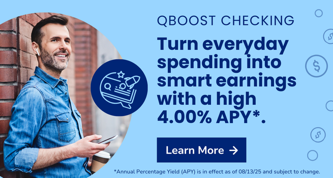 Smiling man on the street looking at his phone.