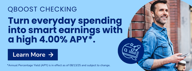 Smiling man on the street looking at his phone.